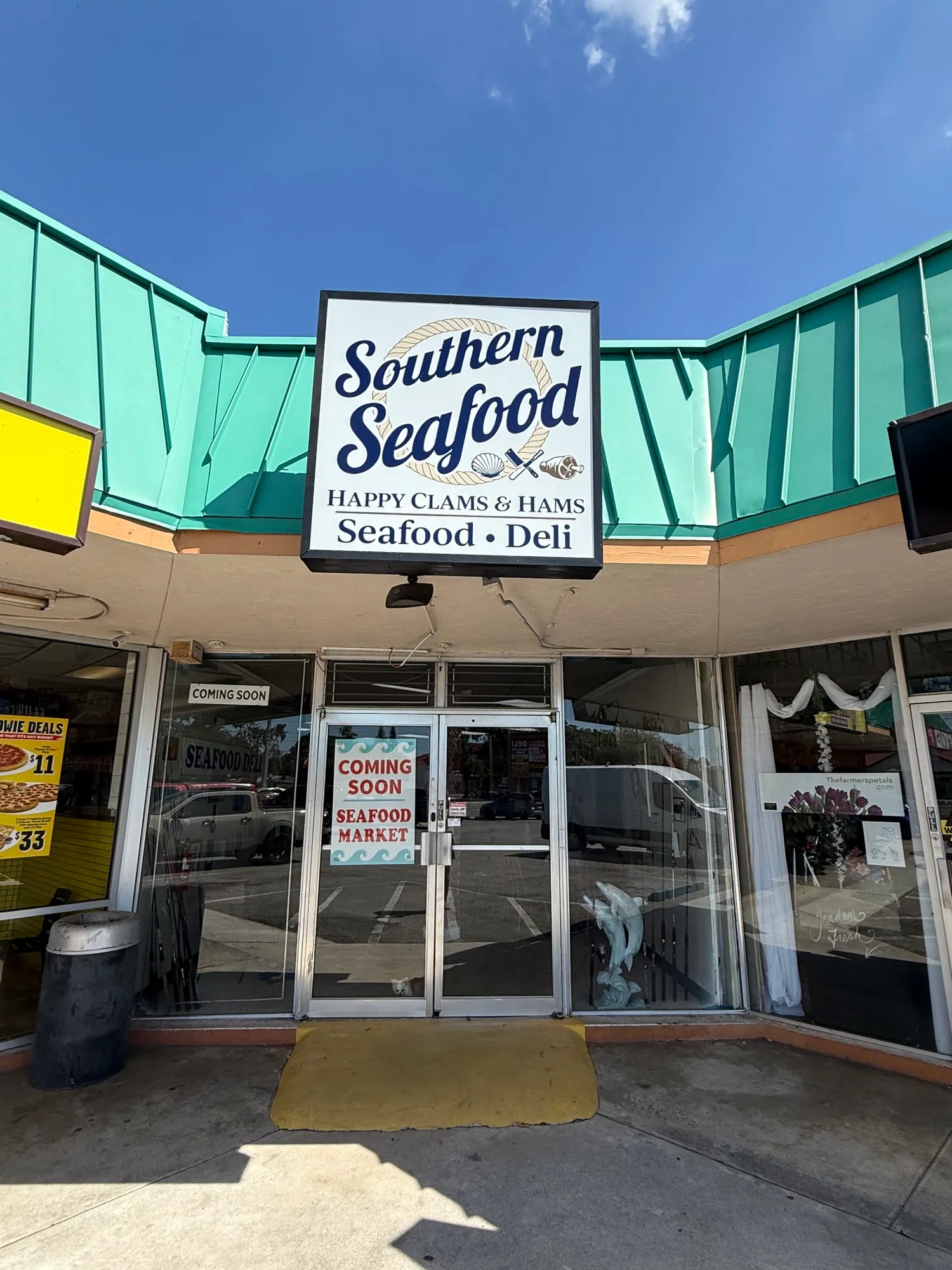 The Happy Clams & Hams storefront on Bee Ridge Road, under the Southern Seafood sign