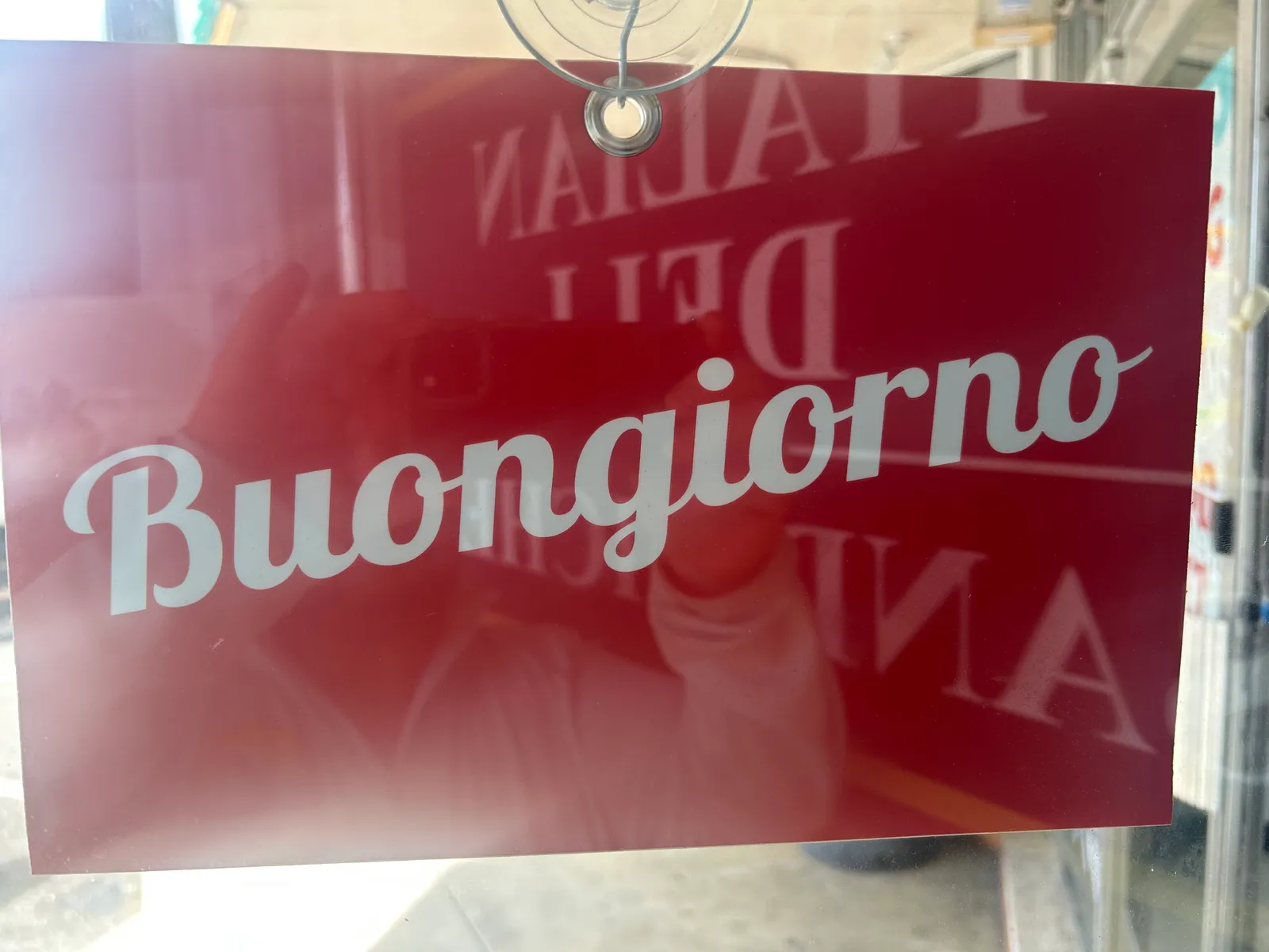 The Buongiorno door card hanging in the window