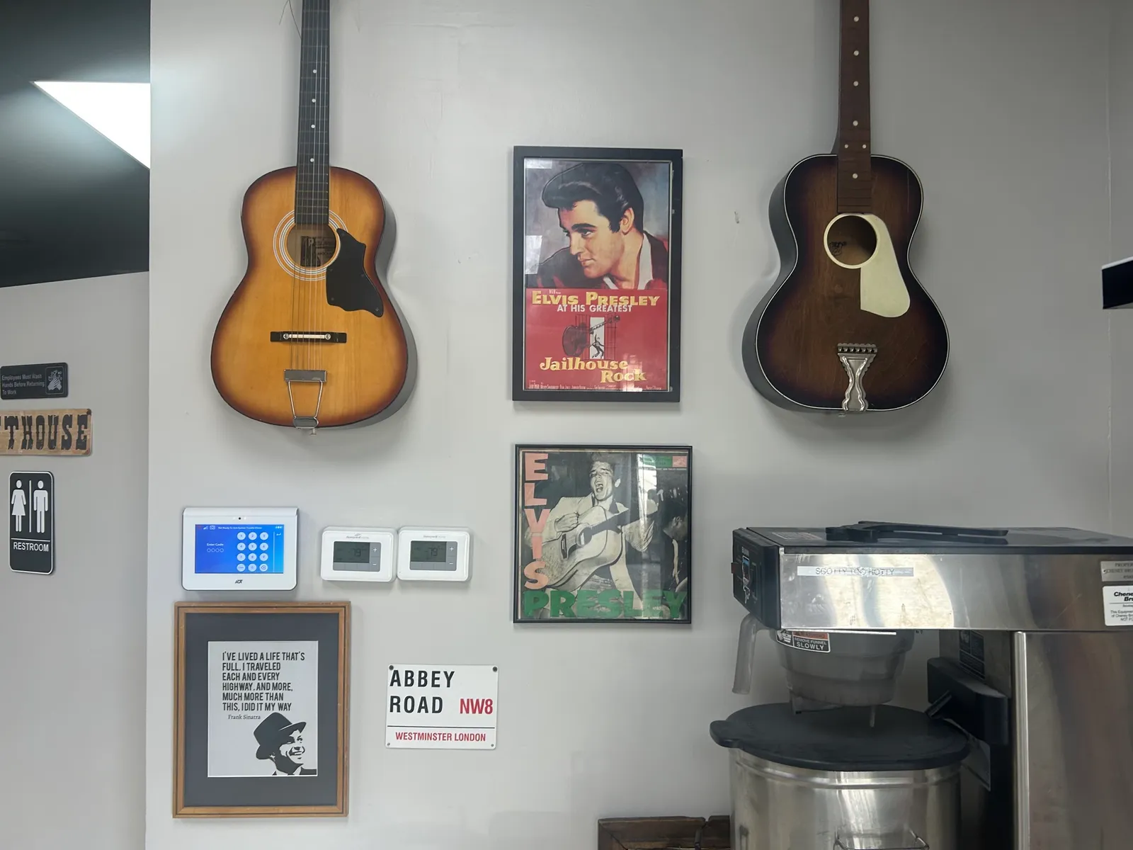 The wall at Happy Clams & Hams: two guitars, Elvis Presley posters, a Sinatra quote and an Abbey Road street sign